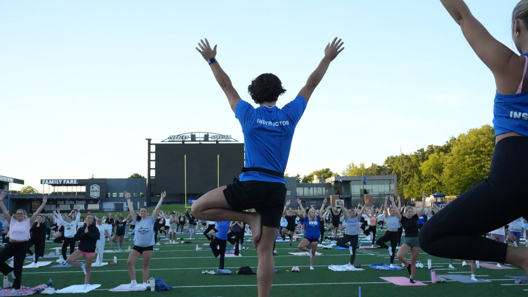 Instructor, Michael, leading Lubber's Yoga in Lubber's Stadium.